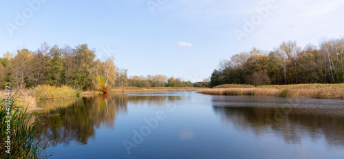Panorama, beautiful autumn landscape. View of the Vorskla river on blue sky background, Ukraine