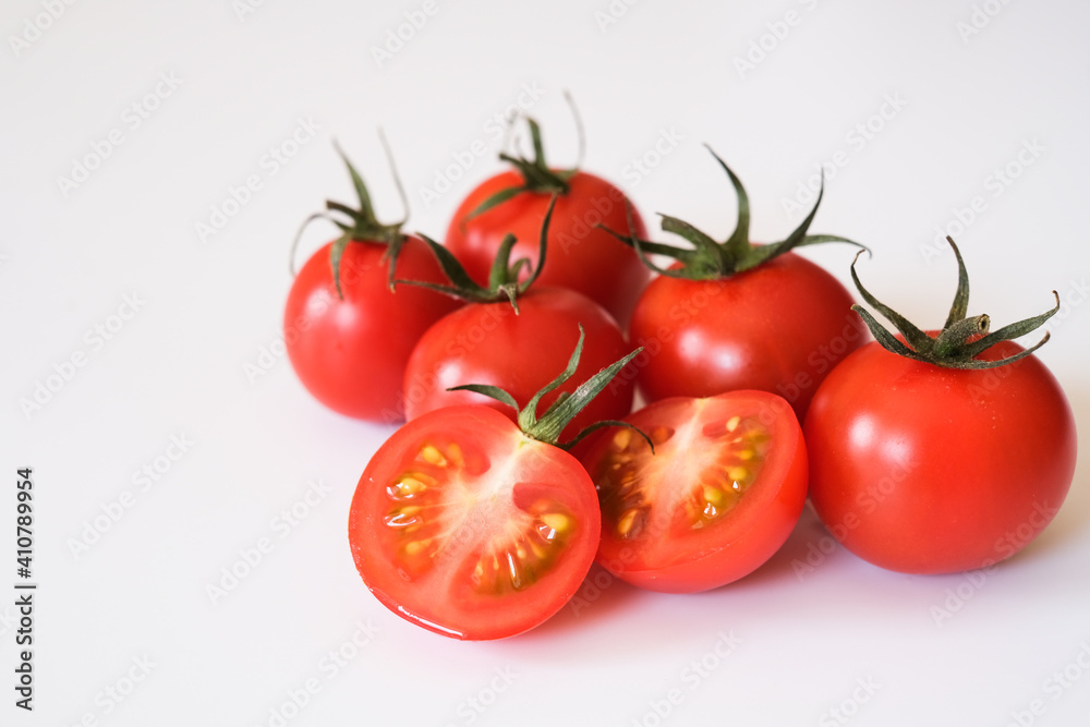 Whole and half Otento sweet diamond tomatoes or cherry tomatoes isolated on white background. Whole and half Otento sweet diamond tomatoes or cherry tomatoes isolated on white background.
