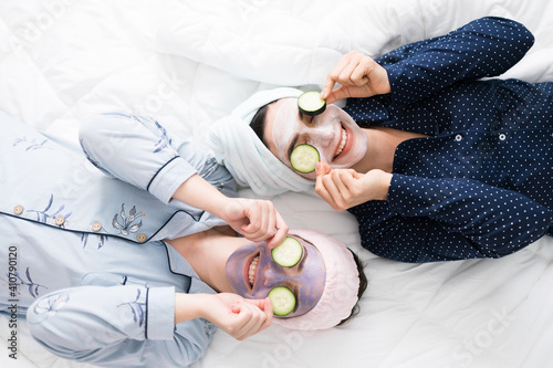 Young women resting in the bedroom while exfoliating their face