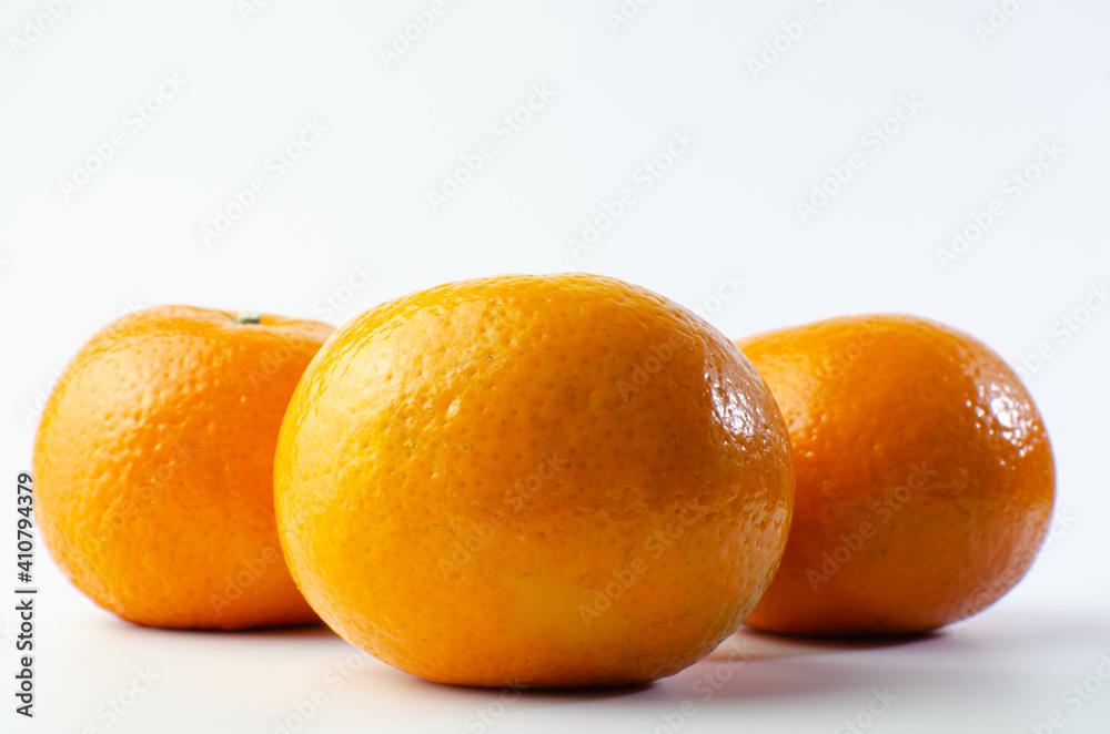 Orange on white background isolated, Asian tropical fruits whole good for healthy drinks and juice. Very natural sweet flavor. Tangerine, mandarine, Thai honey sweet green. Close up shot food concept Orange on white background isolated, Asian tropical fruits whole good for healthy drinks and juice. Very natural sweet flavor. Tangerine, mandarine, Thai honey sweet green. Close up shot food concept