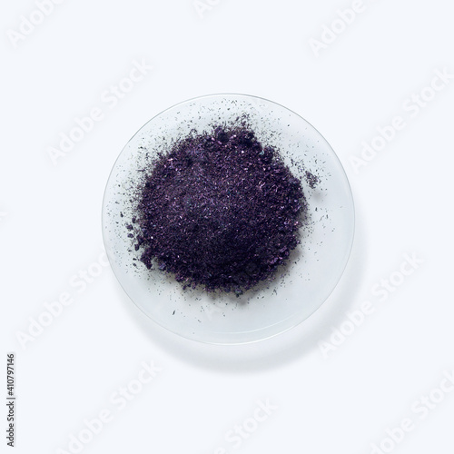 Close up inorganic chemical on white laboratory table. Potassium permanganate (KMnO4), a common chemical compound that combines manganese oxide ore with potassium hydroxide. photo