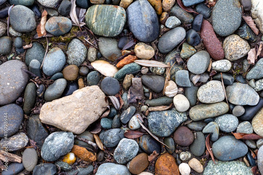 A shallow river, a rocky bottom with a dry riverbed against the background of autumn weather in nature and small pebbles. A shallow river, a rocky bottom with a dry riverbed against the background of autumn weather in nature and small pebbles.
