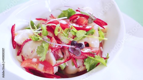 Salad with seafood, tomatoes and herbs. Salad with shrimp and vegetables. Serving dish in a restaurant. Ready dish on the table.