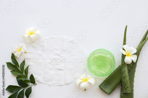 Fototapeta Naklejka Na Ścianę i Meble -  natural aroma sheet mask with soothing gel from herbal aloe vera essence face mask for health care surface beauty skin care of lifestyle woman relax arrangement flat lay style on background white 