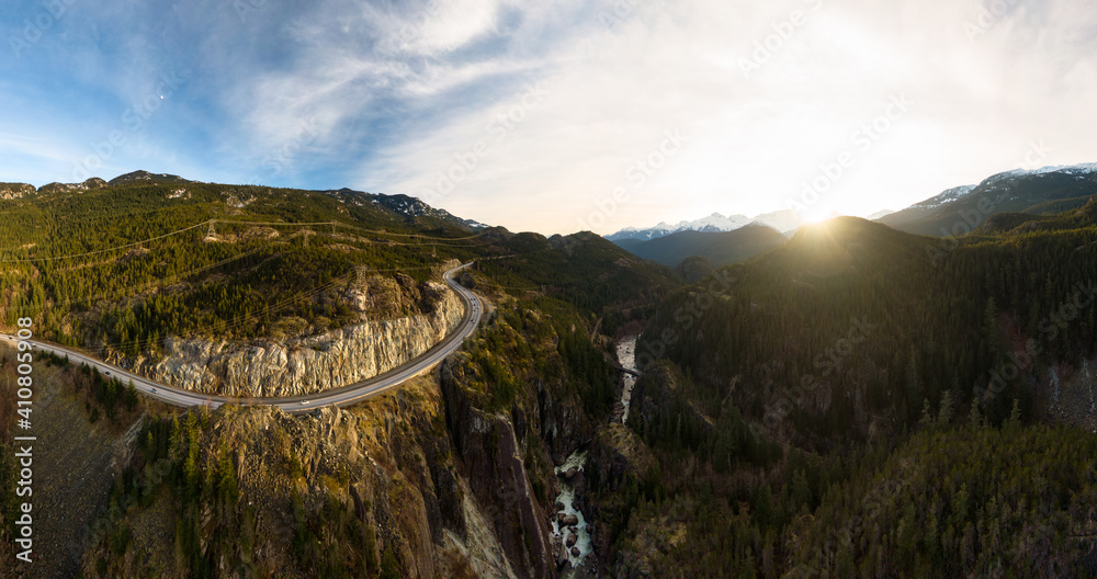 Aerial drone view of Sea to Sky Highway during a bright winter sunset. Taken between Squamish and Whistler, North of Vancouver, British Columbia, Canada.