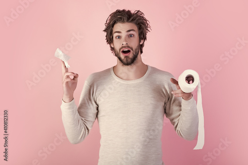 Man with surprised face hold toilet paper. Pandemic. Man in underwear with disheveled hair, morning. Sterility and purity. Hygiene and sanitary. WC and restroom.