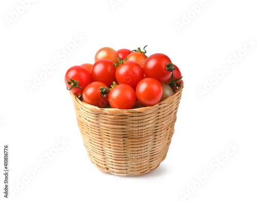 The branch of cherry tomatoes in basket isolated on white background