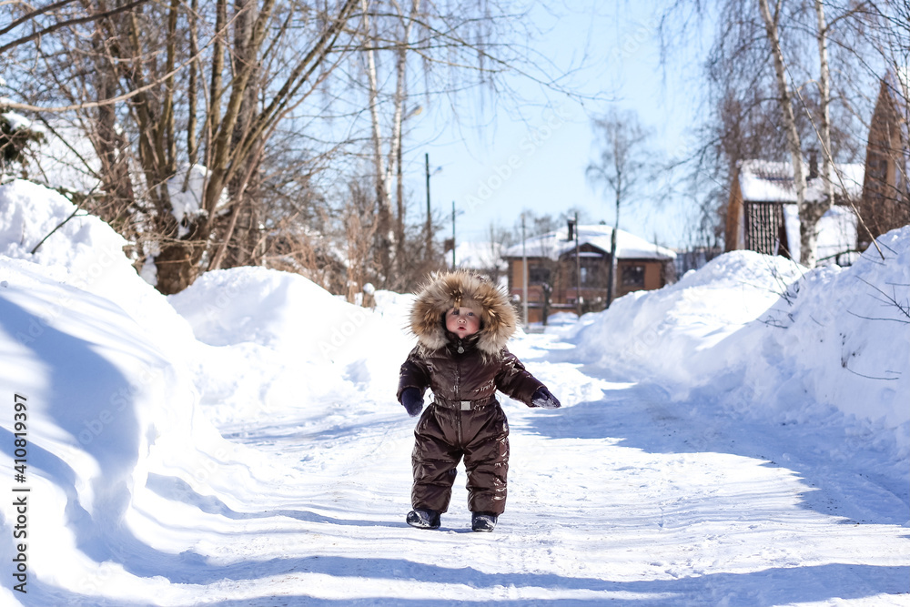 A cute little boy having fun outdoors on a winter day. Wintertime, entertainment, activity, childhood, holidays concept.