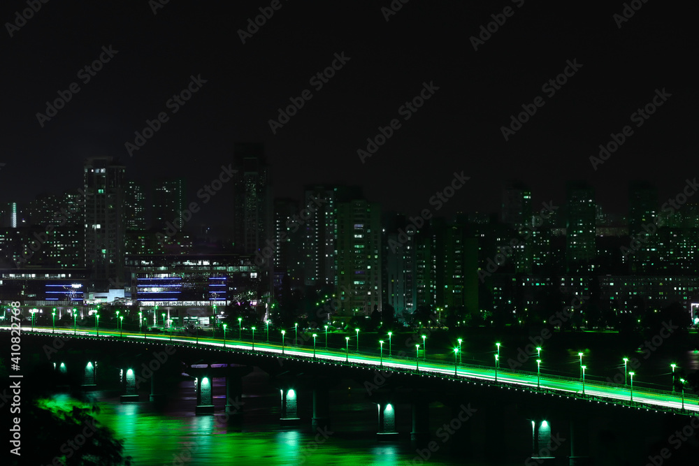 Beautiful view of modern city at night on St. Patrick's Day