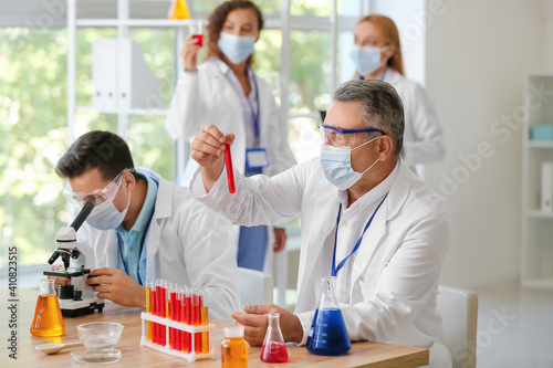 Scientists working with sam...