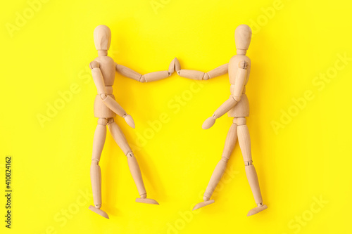 Wooden mannequins holding h...