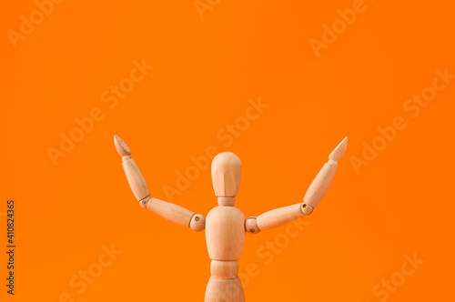 Wooden mannequin raising ha...