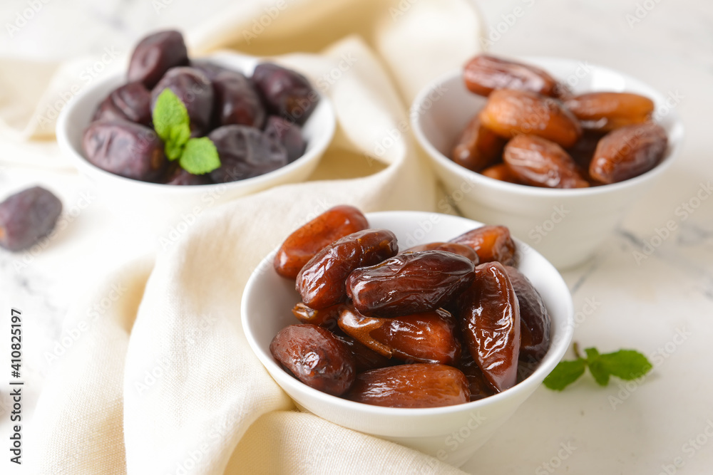 Bowls with sweet dates on light background Bowls with sweet dates on light background