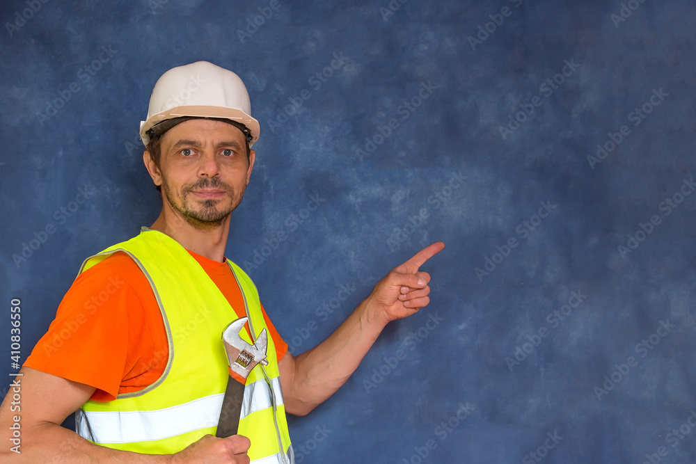 Male locksmith, builder. A worker with a tool in his hands and in working uniform. Male locksmith, builder. A worker with a tool in his hands and in working uniform.