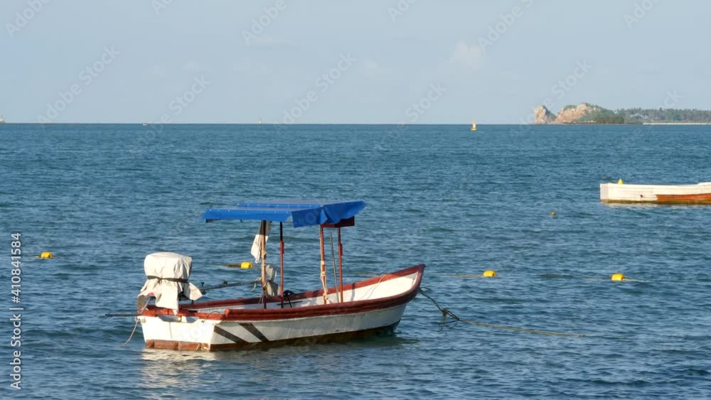 Tranquil blue sea bay with fisherman's boats. Small calm waves Tranquil blue sea bay with fisherman's boats. Small calm waves