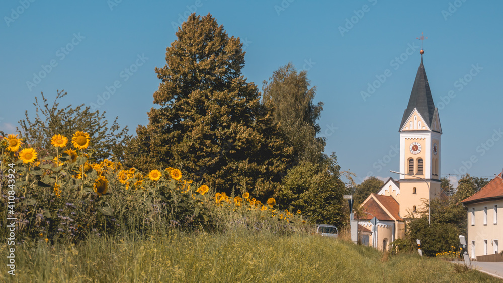 Beautiful church with a sunflower field at Wallerfing, Bavaria, Germany