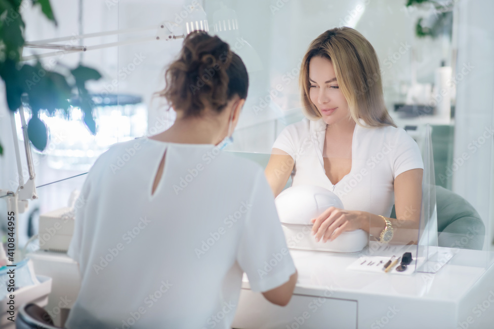 Nail artist working with the client in a beauty salon Nail artist working with the client in a beauty salon