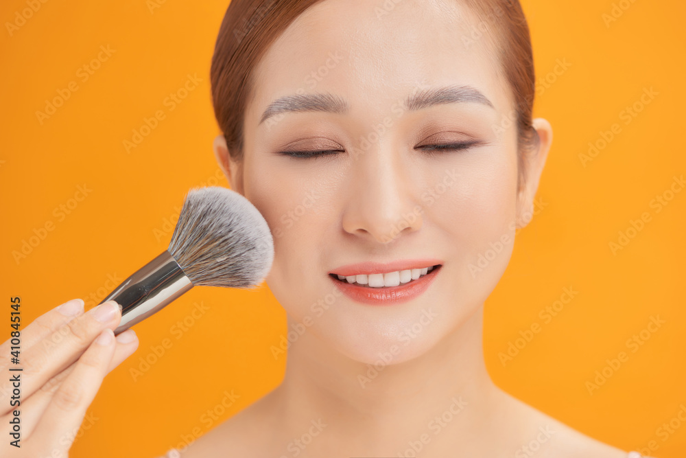 woman applying powder to clean her face skin. woman applying powder to clean her face skin.