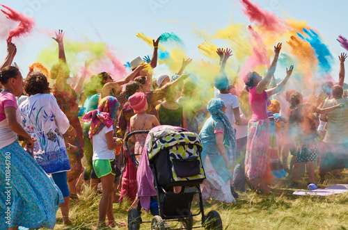 people throw colorful powders in the air at the holi festival