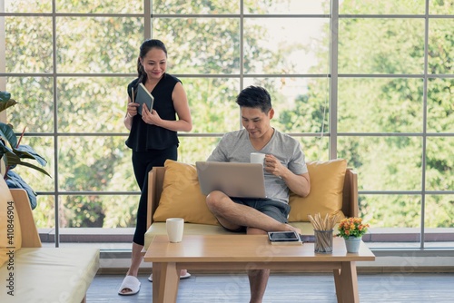 Asian man and woman family in casual outfit in living room doing lifestyle activity together in happy and smile emotion © Supagrit Ninkaesorn