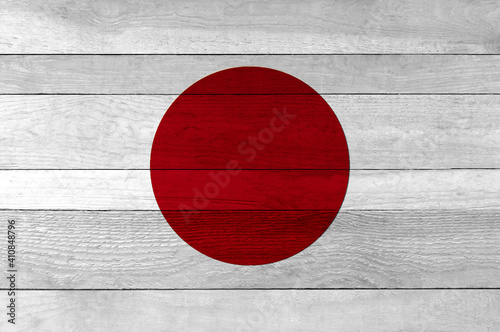 Japan national flag painted on a wooden plank background.