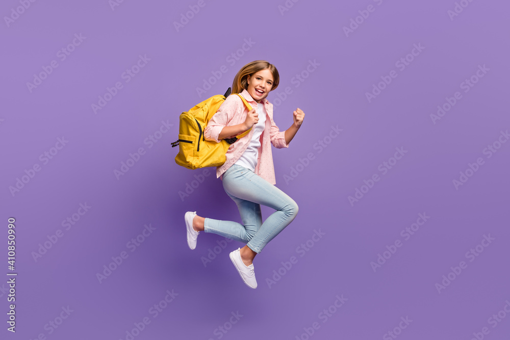 Full size profile photo of hooray pretty girl jump run wear pink shirt jeans sneakers rucksack isolated on violet background