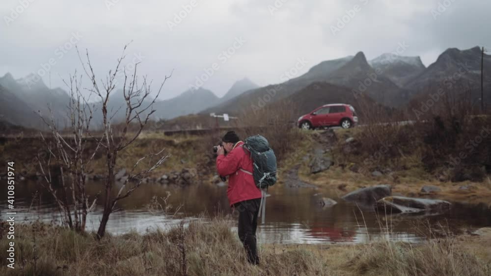 Hiker In Red With Rucksack Taking Photograph Hiker In Red With Rucksack Taking Photograph