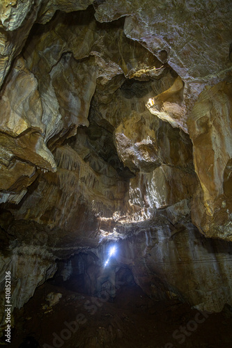 man alone caving deep in the stalactites cave
