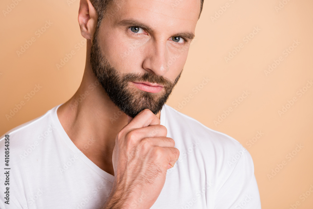 Cropped photo of young handsome stubble man serious think ponder pensive plan hand touch chin isolated over beige color background