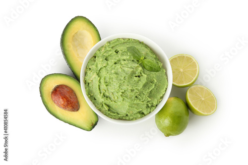 Bowl of guacamole, avocado and lime isolated on white background