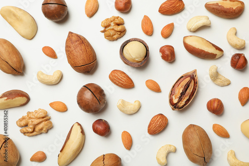 Different tasty nuts on whole background, close up