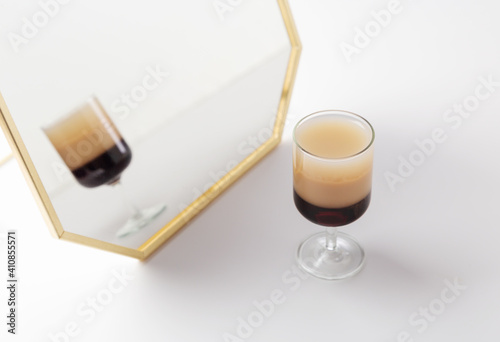 B-52 cocktail with mirror at white background