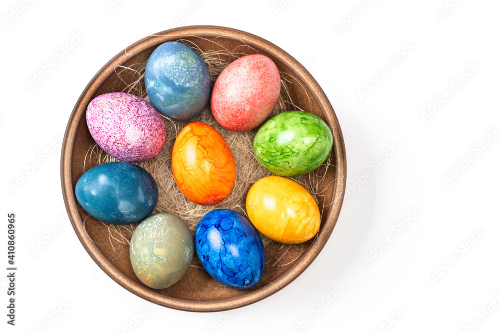 Different easter eggs in ceramic bowl on white Different easter eggs in ceramic bowl on white
