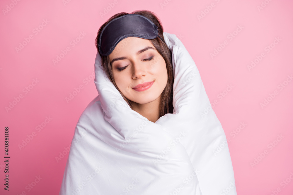 Photo portrait of sleeping woman wrapped in bed sheets isolated on pastel pink colored background Photo portrait of sleeping woman wrapped in bed sheets isolated on pastel pink colored background