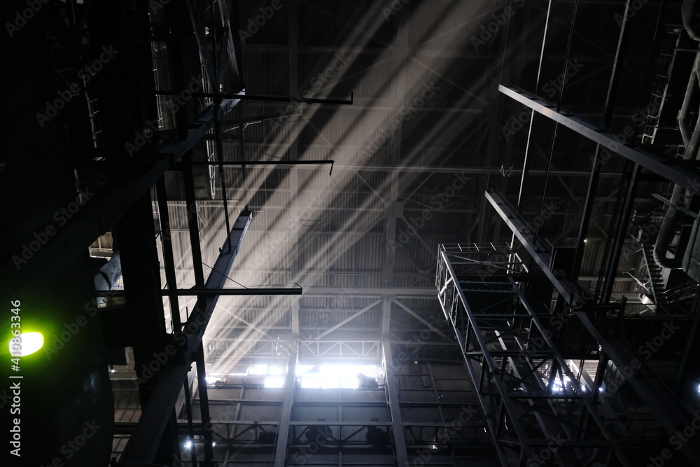 Almaty, Kazakhstan - 02.04.2021 : The light of the sun shines through the metal structures on the heating plant. Almaty, Kazakhstan - 02.04.2021 : The light of the sun shines through the metal structures on the heating plant.