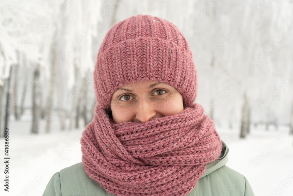 Portrait of a girl in a red hat and scarf outdoors in winter Portrait of a girl in a red hat and scarf outdoors in winter