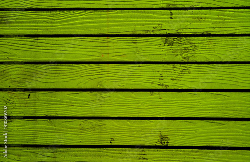 Lime green colored horizontal pattern old wooden fence background