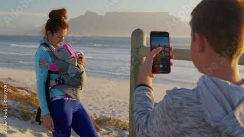 Son photographs mom and child against the backdrop of the table mountain at sunset, South Africa. photo