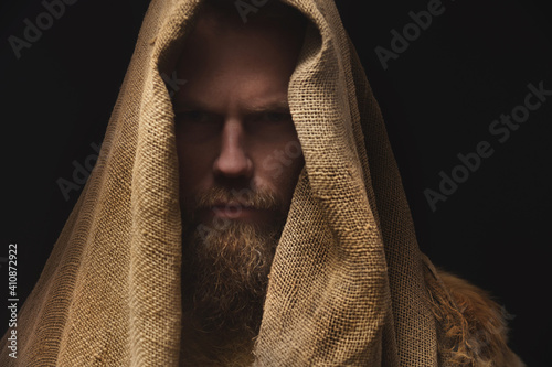 Fototapet Portrait of a medieval bearded war monk dressed in animal skins and sacking