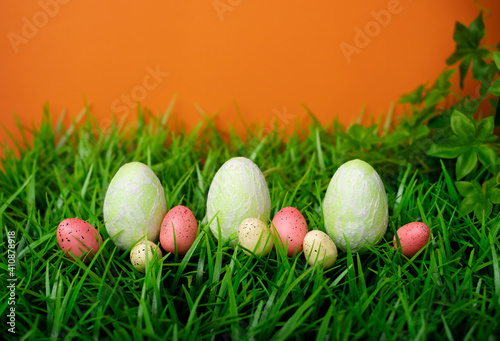 Easter chicken and quail eggs on the meadow grass