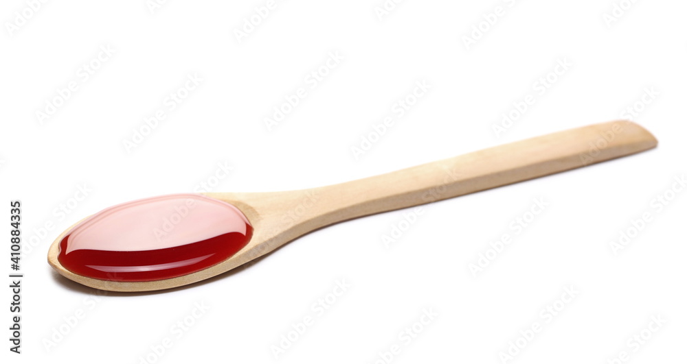 Blackcurrant fruit nectar, juice puddle with wooden spoon isolated on white background