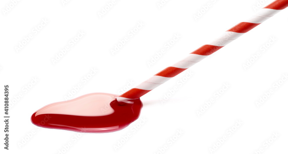 Blackcurrant fruit nectar, juice puddle with paper drinking straw isolated on white background Blackcurrant fruit nectar, juice puddle with paper drinking straw isolated on white background