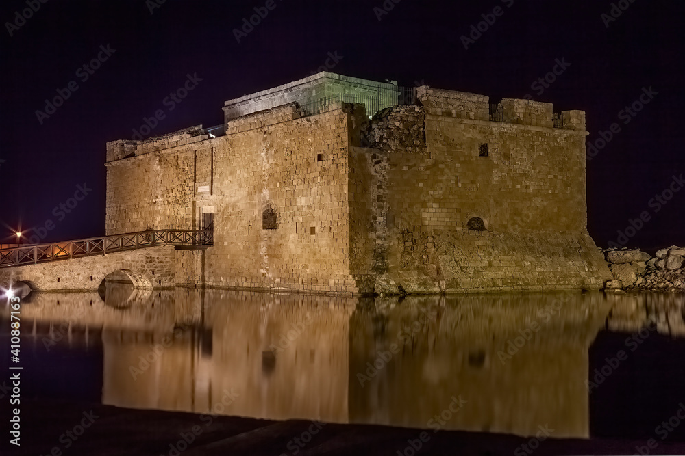Paphos Castle in Cyprus at night which is now a museum in the harbour and is a popular tourist travel destination attraction landmark of the Mediterranean island, stock photo image