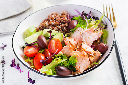 Salmon salad. Fresh salad with grilled salmon, avocado, cherry tomatoes, lettuce, quinoa, olive and microgreens. Homemade food. Concept healthy meal