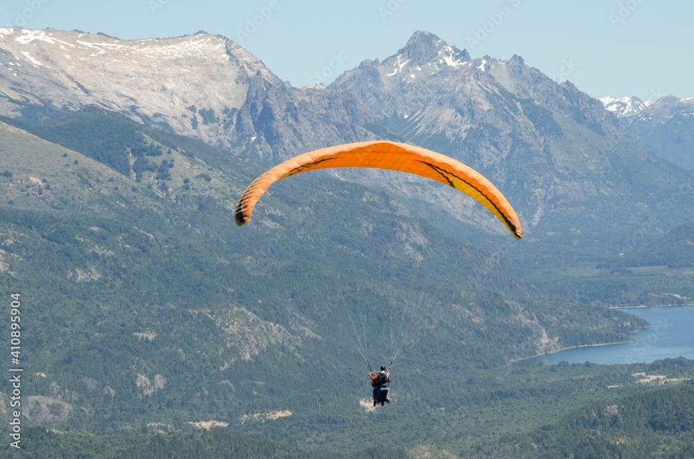 paraglider, instructor and passenger flying over lakes and mountains of bariloche paraglider, instructor and passenger flying over lakes and mountains of bariloche