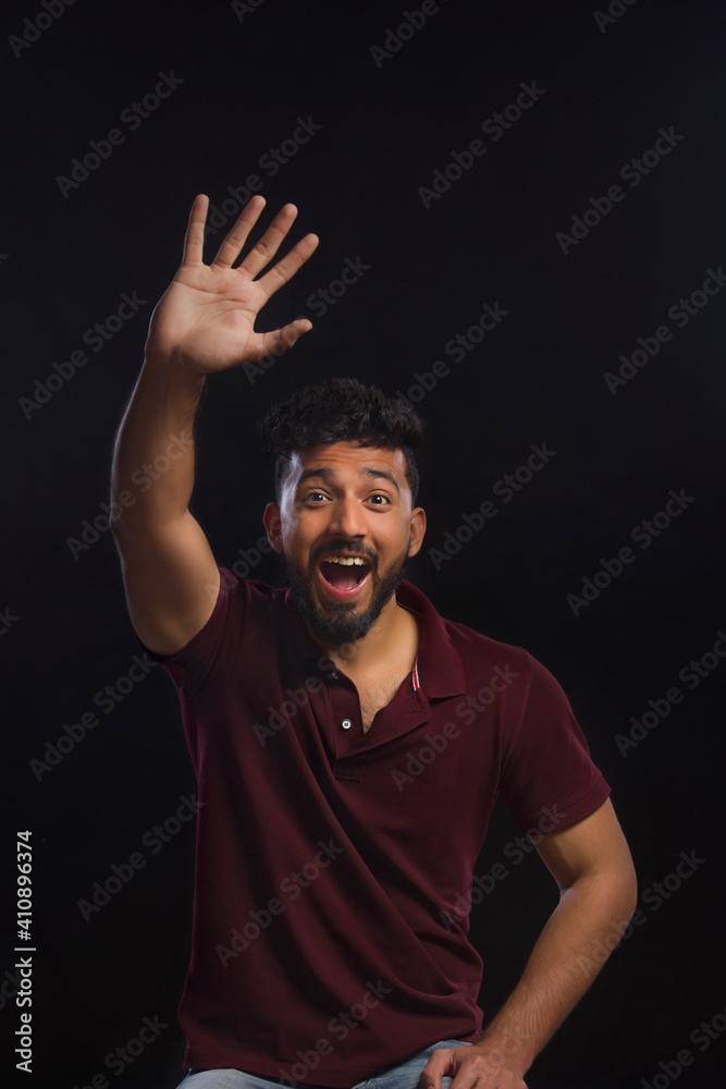 Young man waving in excitement. 	