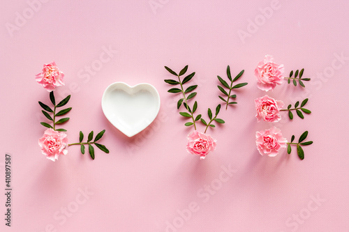 Word Love for greeting card of flowers and leaves. Top view
