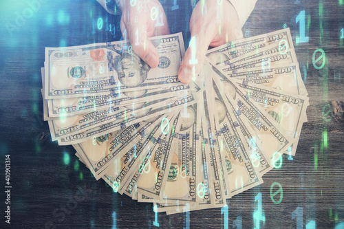 Multi exposure of technology drawing hologram and us dollars bills and man hands. Data concept photo