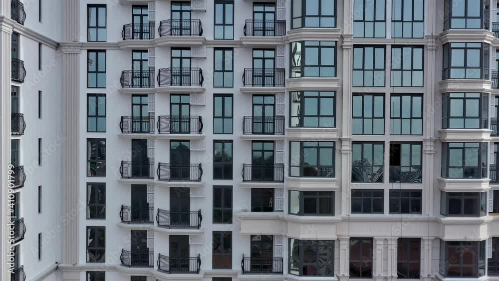 Aerial shot of modern high rise apartment complex. Tall big building with many windows and sky with clouds, Sochi Russia Aerial shot of modern high rise apartment complex. Tall big building with many windows and sky with clouds, Sochi Russia