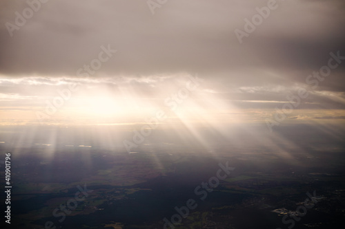 beams of sun light through the clouds on the hills